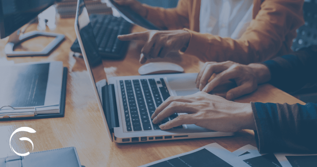 financial advisor succession; people work together on laptops at a table