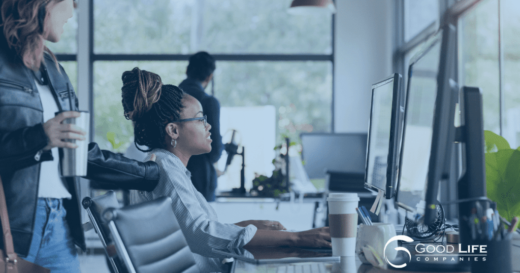 a woman sits in an office lit with natural light