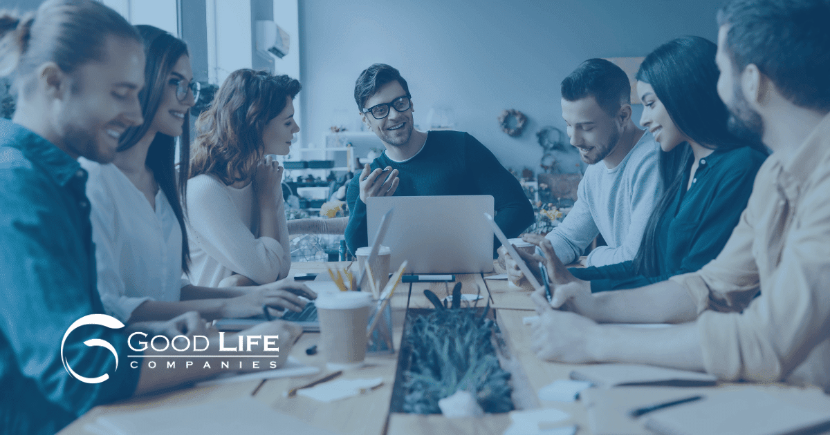 a group of financial advisors have a digital marketing meeting at a table